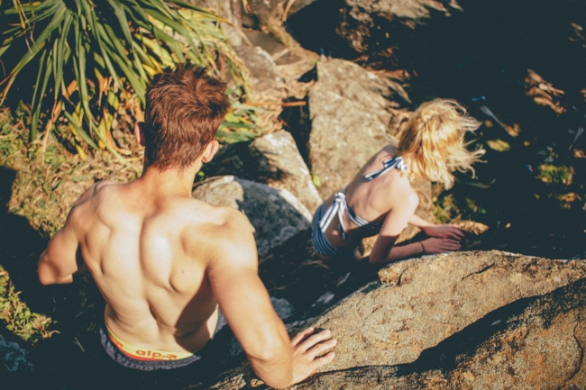 man and woman rock climbing hiking couple