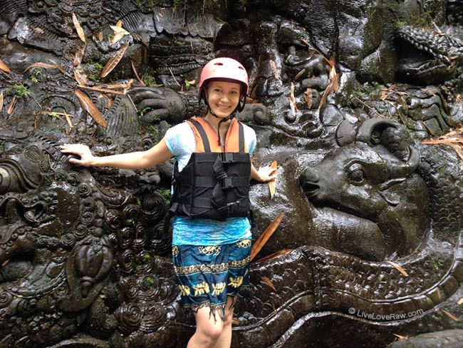 Anya Andreeva on Ayung river, Bali, white water rafting, carvings wall