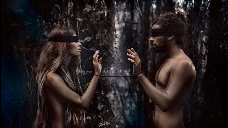 Man and woman, blindfolded, attached to each other by a string, spiritual relationship