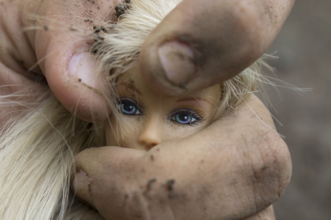 barbie-doll-head-being-squeezed-domestic-violence