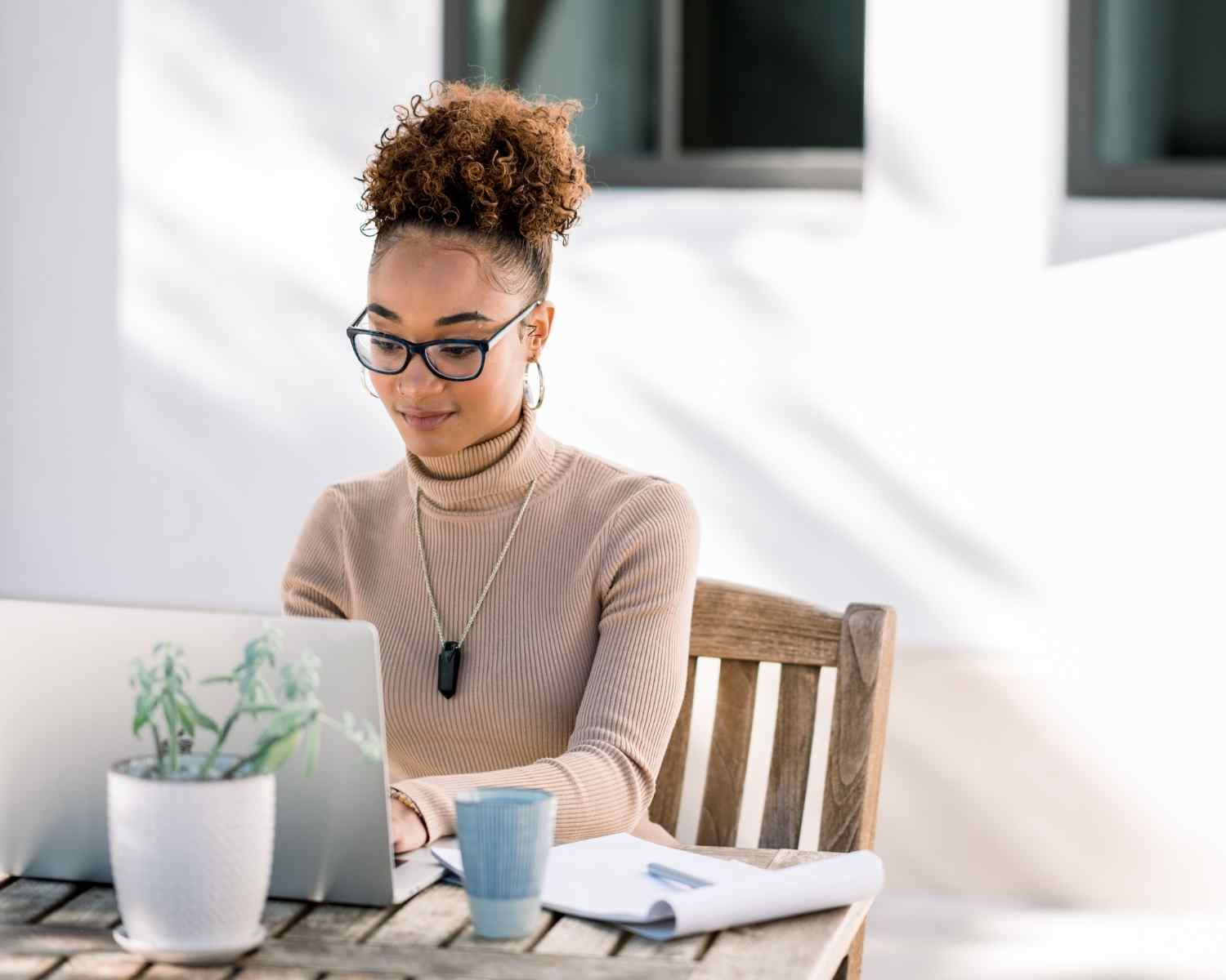 black woman working from her on her laptop