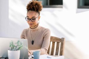 black woman working from her on her laptop